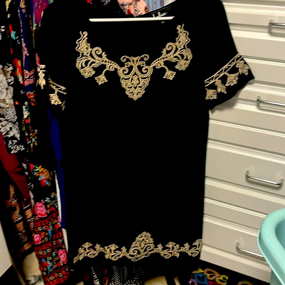 Cute short black dress w details around neckline and thigh point